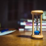 hourglass on brown wooden frame